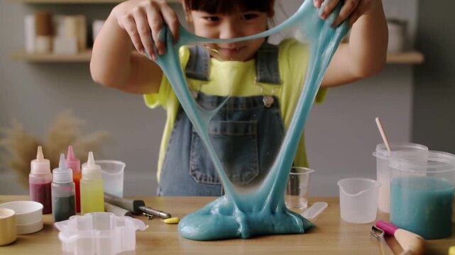 Child enjoying blue slime play