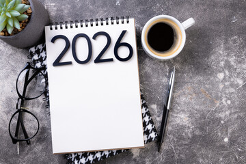 New year goals 2026 on desk. 2026 resolutions list with notebook, plant on table. Resolutions, plan, goals, action, checklist, idea concept. New Year 2026 resolutions, copy space