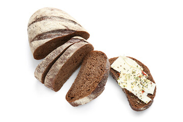 Sliced bread with butter and herbs on white background