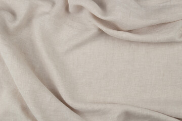 Beige linen fabric with soft folds, natural eco textile texture for minimalist background