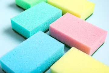 Colorful cleaning sponges on blue background