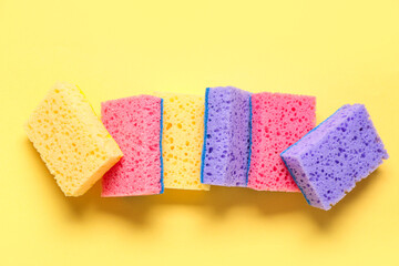 Cleaning sponges on yellow background