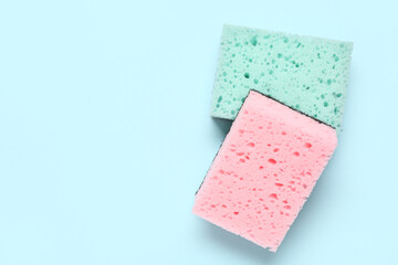 Cleaning sponges on blue background