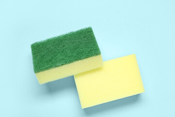 Yellow cleaning sponges on blue background
