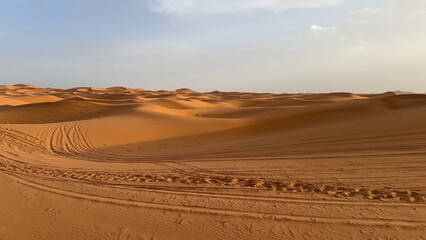 A trip to Sahara desert in Morocco. Beautiful 
african travel photo. Sandy landscapes, sandy 
dunes, and nature. Summer vacation in arab country.