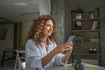 Woman working remotely during video call using smart phone