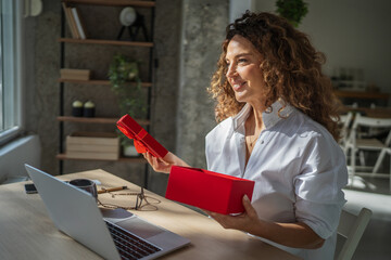 Woman opening red gift box, receiving surprise present