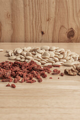 Macro detail of salted roasted almonds, flame-roasted raisins, walnut halves, and goji berries on velvet