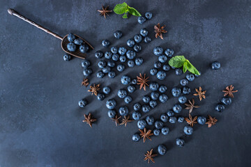 Sustainably grown blueberries on a black velvet background and an inlaid damascene steel spoon