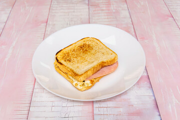Tuna sandwich with corn salad and homemade mayonnaise between lightly toasted whole-wheat bread