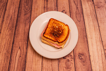 Mortadella sandwich with pistachios, mozzarella cheese, and basil pesto on toasted bread