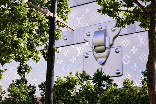 Louis Vuitton building facade with trees in Paris, France