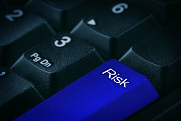 Blue button with word Risk on computer keyboard, closeup