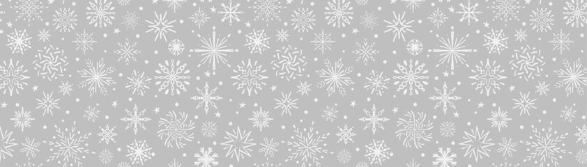 Christmas background seamless snowflake pattern. White snow  on silver background winter pattern. Hand drawn snowflakes print for festive decoration