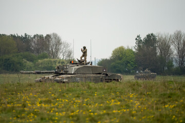 British army Challenger 2 II FV4034 main battle tank with Warrior FV510 IFV in action on a military exercise