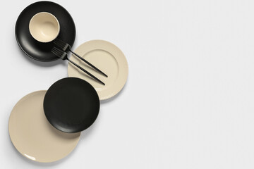 Stylish ceramic plates with forks on white background