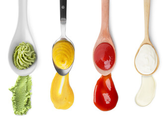 Mustard, ketchup, mayonnaise and wasabi isolated on white, set. Top view