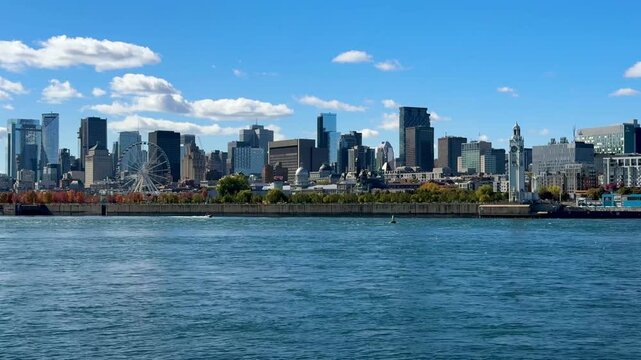 Montreal, Canada - October 08, 2025: Montreal skyline photographed from Parc Jean-Drapeau. The St. Lawrence River in the foreground.