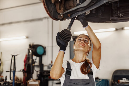 A skilled female mechanic repairing a car, highlighting womens important role in the automotive industry
