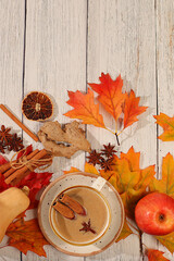 Seasonal abstract composition with hot autumn drink, coffee with foam, and Indian masala chai and fallen leaves, star anise and cinnamon, banner for screen, autumn greeting concept, mockup for menu.