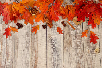 Frame with maple leaves, cinnamon, nuts, anise, autumn abstract composition, Thanksgiving concepts, seasonal background, greeting card or invitation, screen banner, autumn greeting concept.