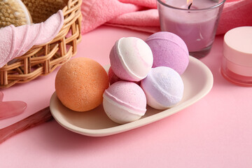 Composition with tray and different bath bombs on pink background, closeup