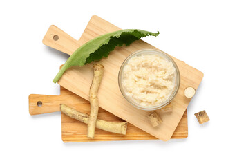 Bowl of horseradish sauce with root and leaf on white background