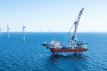 Wind farm installation ship in the Baltic Sea with helicopter on the helicopter landing pad.
