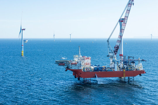 Wind farm installation ship in the Baltic Sea with helicopter on the helicopter landing pad.