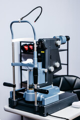 Ophthalmology equipment featuring a laser vision correction device on a table, showcasing advanced technology for vision examination and patient care in a clinical setting