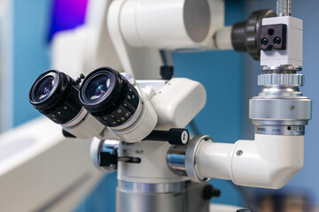 Ophthalmic microscope with dual eyepieces and precision focus knobs, showcasing advanced technology in a modern clinical environment for vision examination