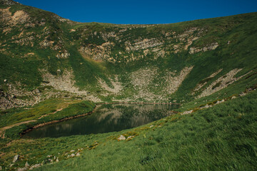 Landscape with mountain lake Brebeneskul. Green carpathian nature