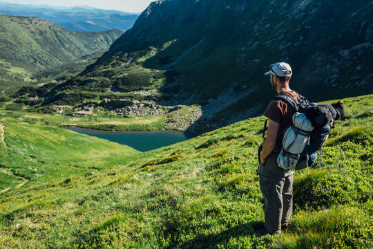 Tourist in the mountains watching a beautiful lake