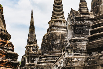 Old Buddhist temple ruins in a green park landscape in Ayutthaya, Thailand