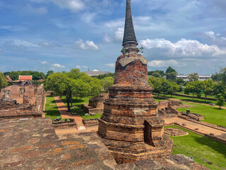 Old Buddhist temple ruins in a green park landscape in Ayutthaya, Thailand