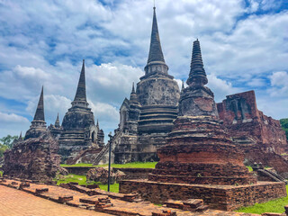 Old Buddhist temple ruins in a green park landscape in Ayutthaya, Thailand