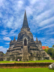 Old Buddhist temple ruins in a green park landscape in Ayutthaya, Thailand