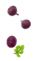 Flying fresh ripe figs and leaf on white background