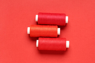 Spools of thread on red background