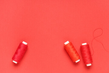 Spools of thread on red background