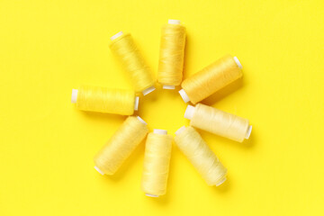 Spools of thread on yellow background