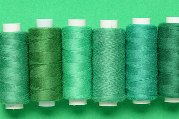 Spools of thread on green background