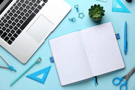 Set of school stationery with laptop and houseplant on blue background - Powered by Adobe