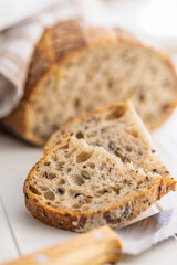 Photo of sliced ​​baked sourdough bread on white table.