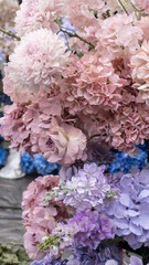 Pink chrysanthemum, hydrangea, delphinium, rose in a floral wedding arrangement. Arch on the podium. Pink purple and blue colors. Festive atmosphere