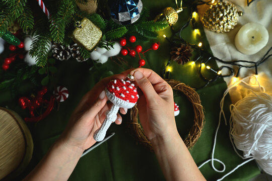 Merry Christmas. Crochet red fly agaric mushroom for your Christmas tree decoration. DIY Christmas tree decorations. Celebrating with kids. A cozy home on Christmas Eve.