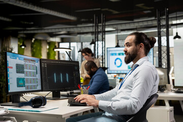 Focused employee using AI digital tools and machine learning models, performing data analysis and prediction for innovation creating adaptive optimized business solutions. Cloud computing