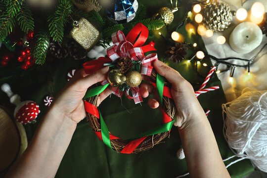 Merry Christmas. New year's toys in hand. DIY Christmas wreath to decorate the Christmas tree. DIY toys. Holiday with children. Cozy home on Christmas eve.