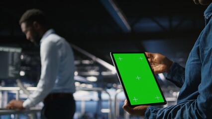Data center engineers monitoring neural network LLM visualization using green screen tablet. Server...