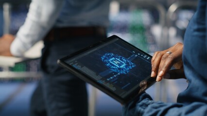 Close up of data center engineer using tablet, doing maintenance on rigs handling AI processing...